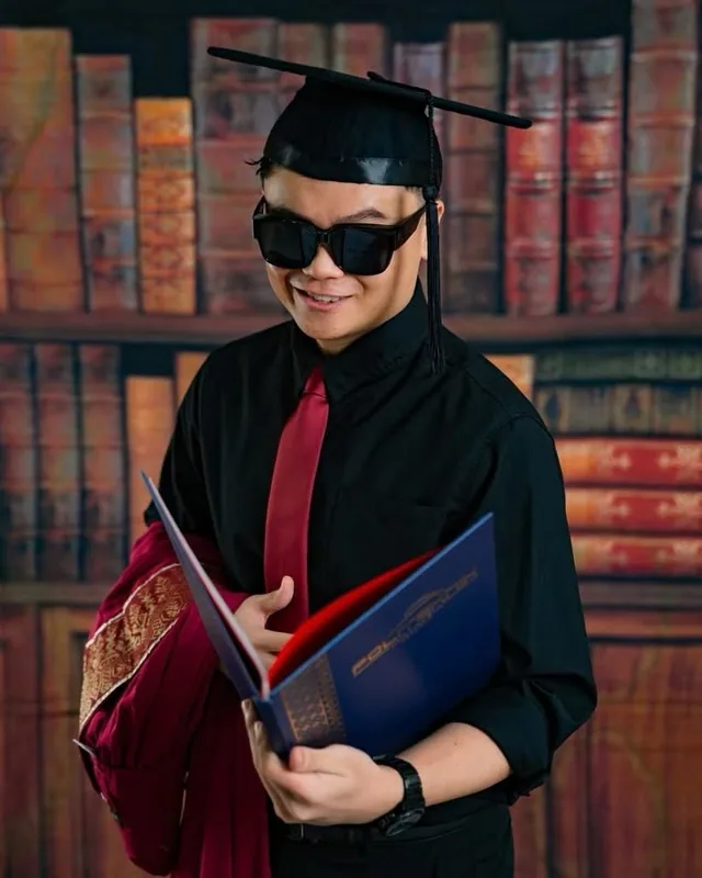 Playful graduate portrait with sunglasses